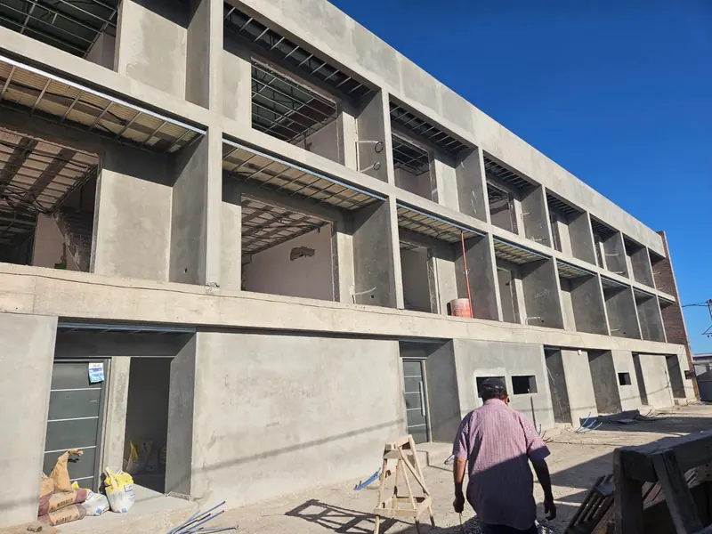 Two storeys of exposed reinforced concrete with slabs and openings already built during the works