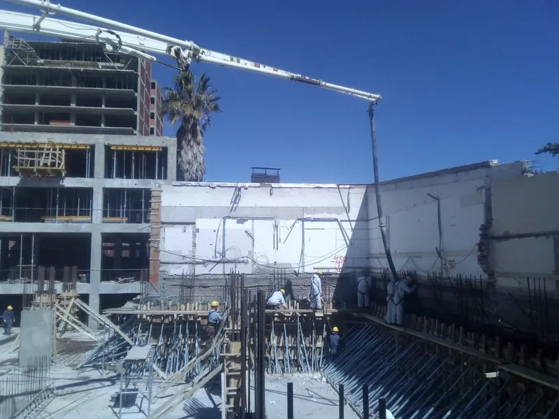 Concrete boom pump with the boom extended during the structural pour