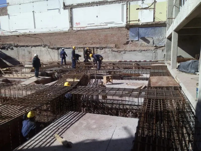 Crew working on the rebar mat of the foundation slab
