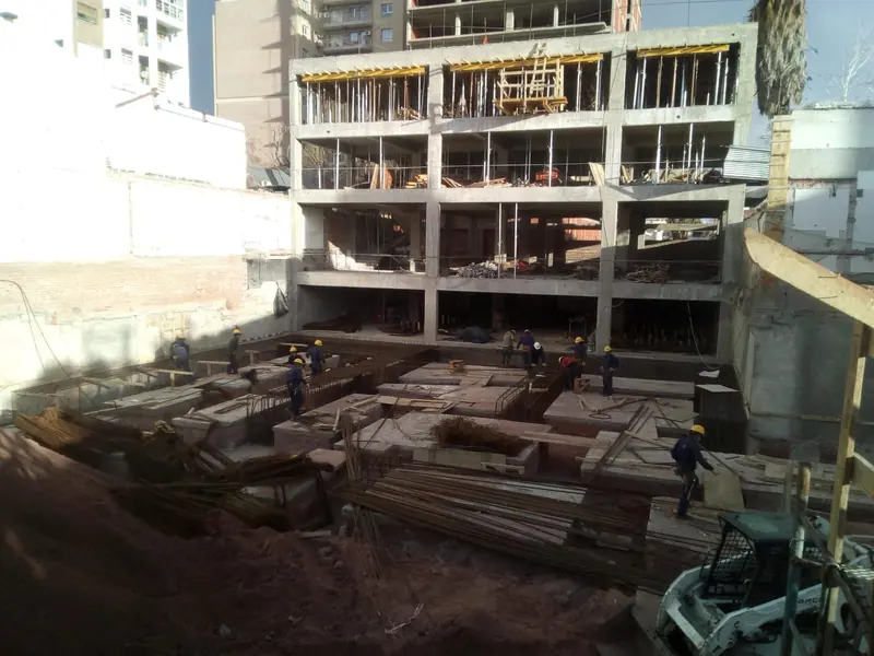 Formwork and materials stacked at the foot of the concrete structure under construction