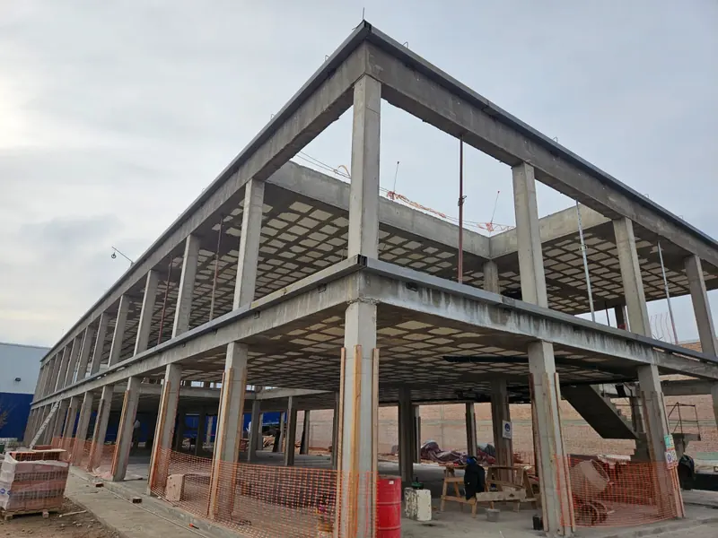 Two-storey concrete frame of the building under construction with slabs already in place
