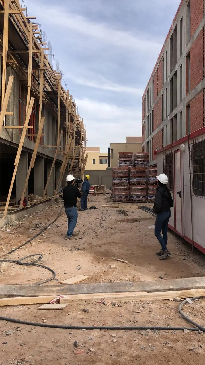Blocks of the complex under construction with timber formwork and brick masonry
