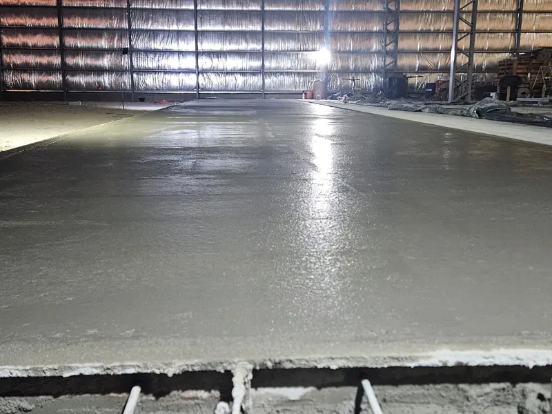 Newly finished industrial concrete floor inside the shed, backlit