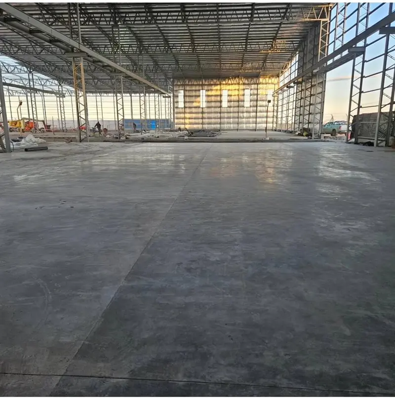 Industrial shed with finished concrete floor and translucent cladding on the gable end