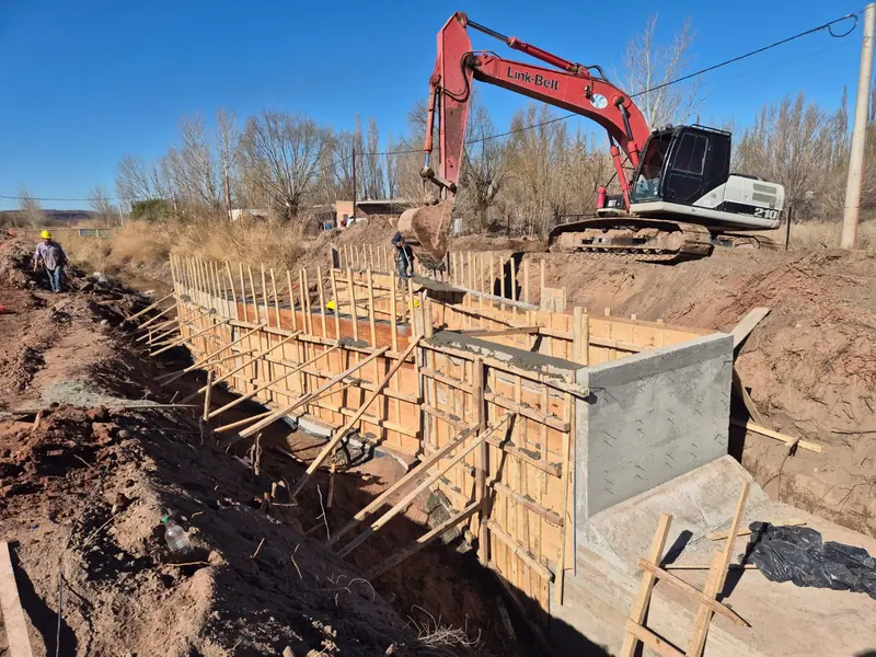 Steel reinforcement and wall formwork with an excavator working in the background