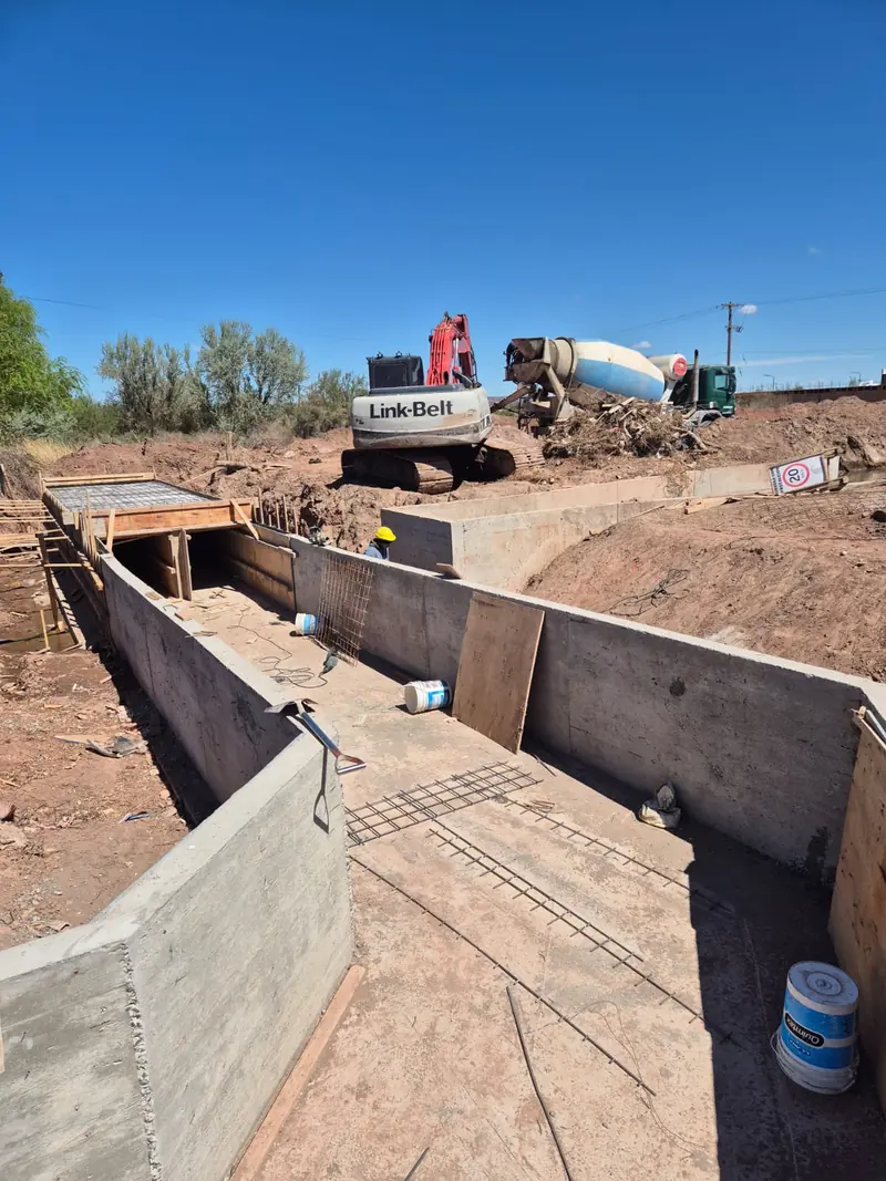 Concrete channel with reinforced base slab and side walls completed