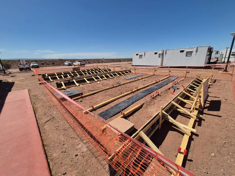 Linear ground beam formwork with polythene sheeting on the plateau ground