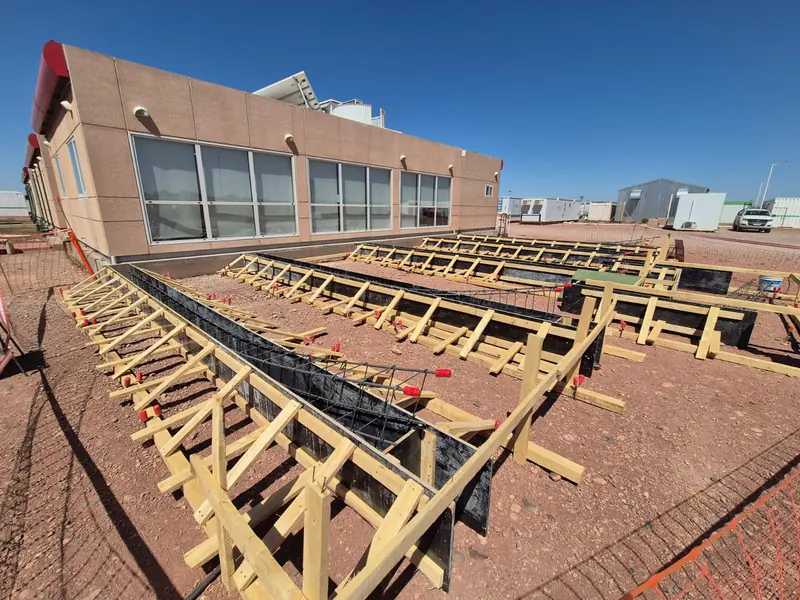 General view of the foundation formwork surrounding the field office building