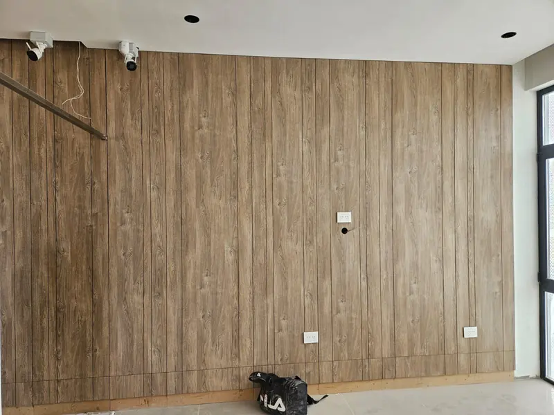 Interior wall clad in timber battens with security cameras installed