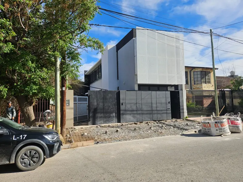 View of the two-storey commercial building from the sidewalk, with the facade finished