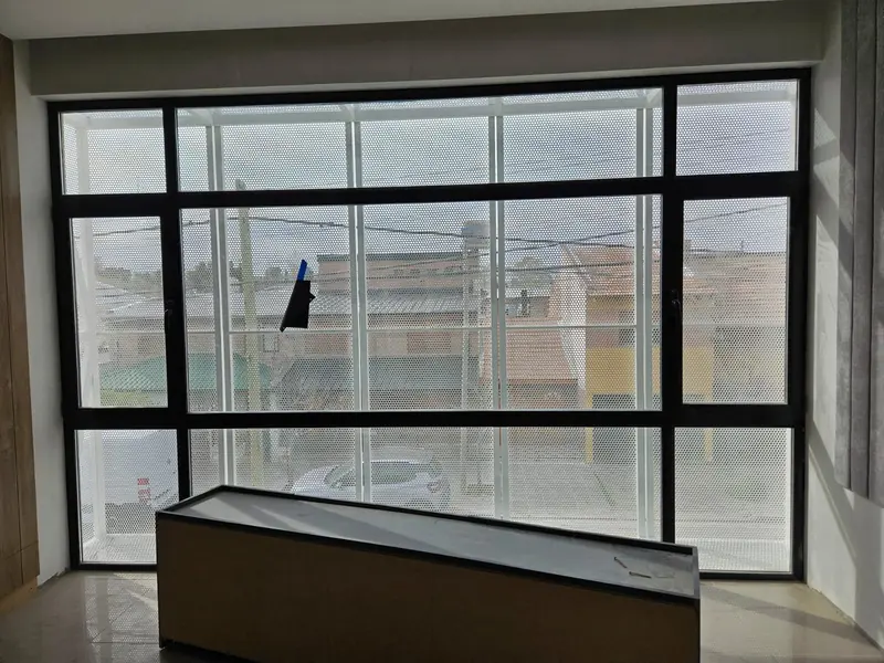 Floor-to-ceiling window with black aluminium joinery and a timber counter