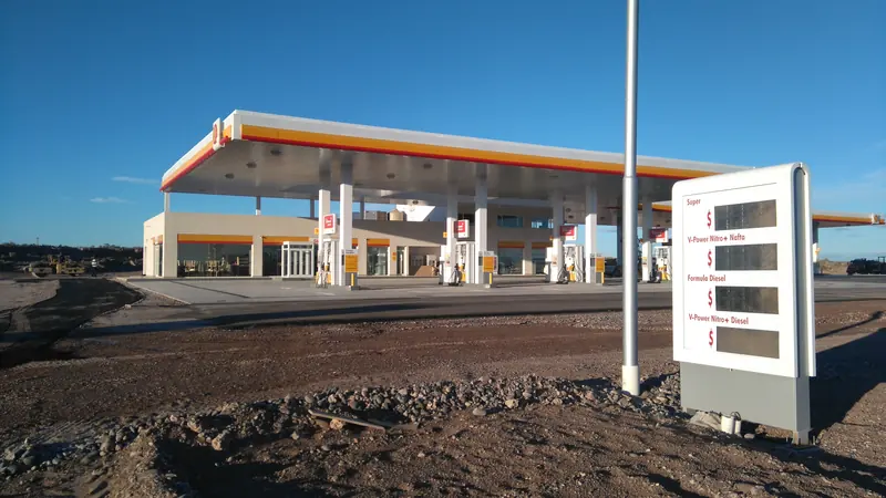 Completed Shell service station with lit canopy, pumps and price totem