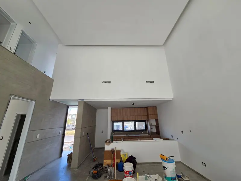Double-height interior with finished ceiling and timber kitchen units