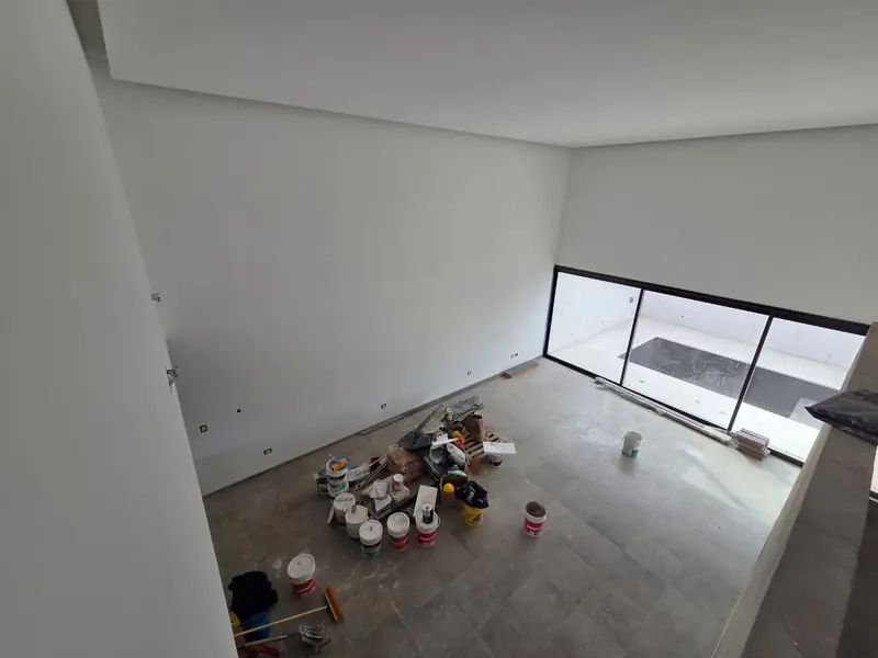 Interior room finished in white with large window and power-floated concrete floor