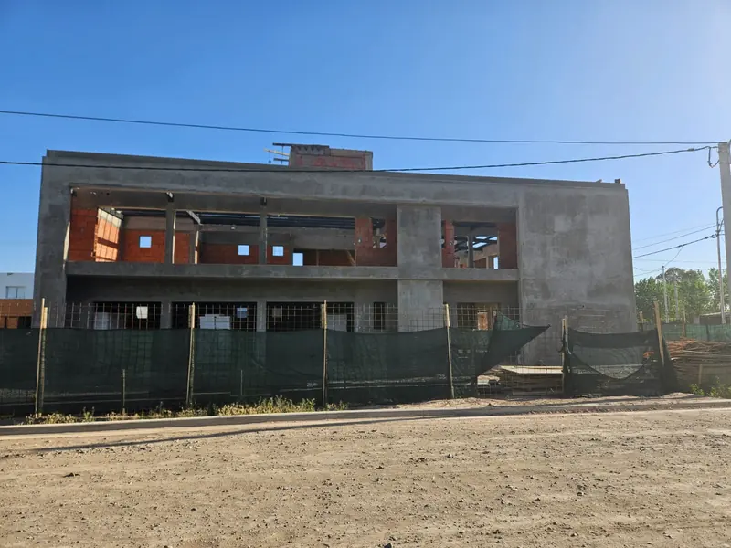 Building under construction with exposed concrete structure and masonry