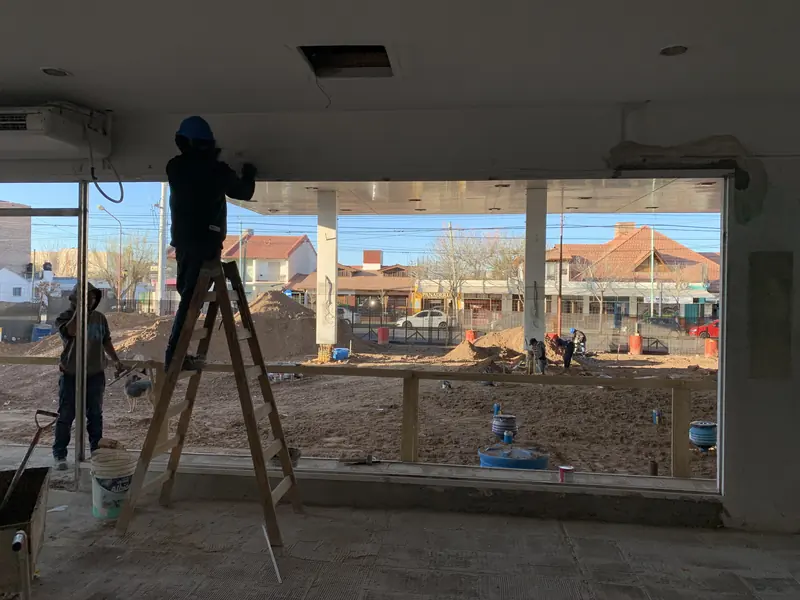 Finishing works inside the shop with a window onto the forecourt under construction
