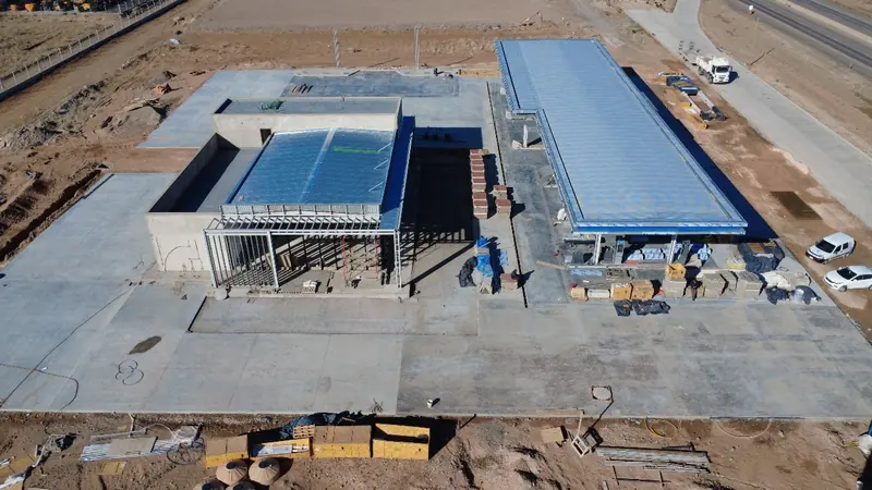 Aerial view of the station under construction with sheet metal roofs and concrete forecourt