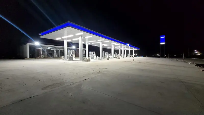 YPF station canopy lit at night with the forecourt completed