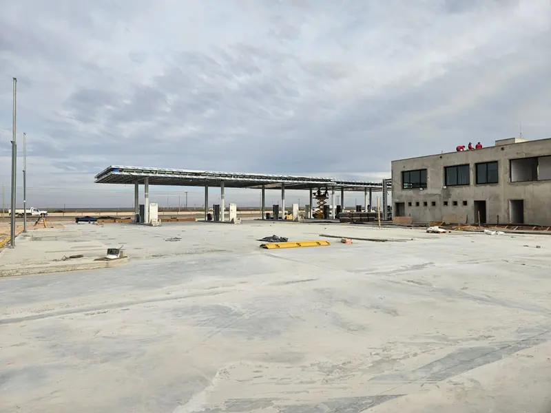 Steel canopy erected and building under construction on an overcast day