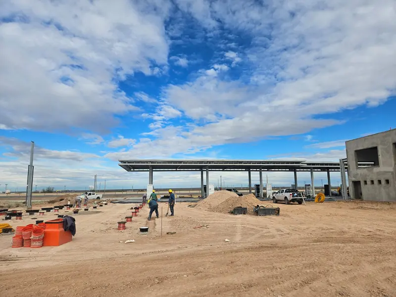 Workers on the forecourt under construction with the steel canopy already erected