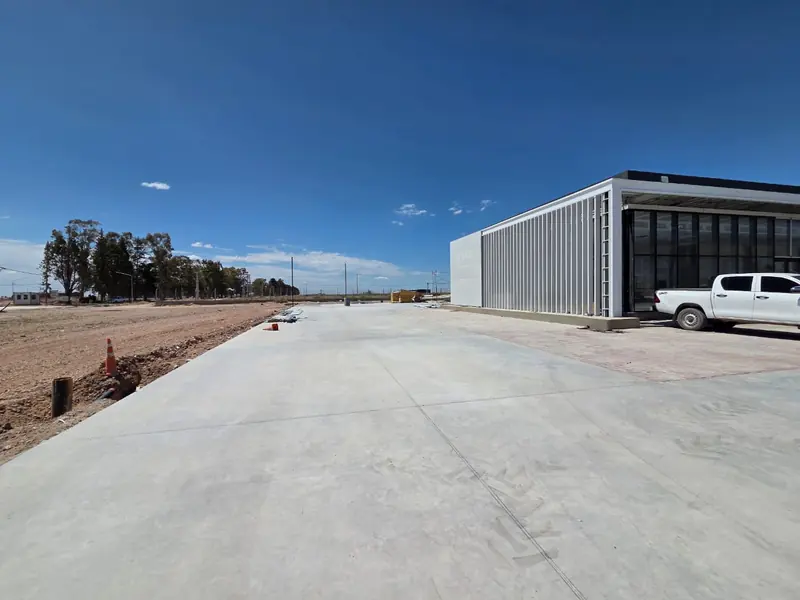 Finished concrete forecourt with the services building along one side