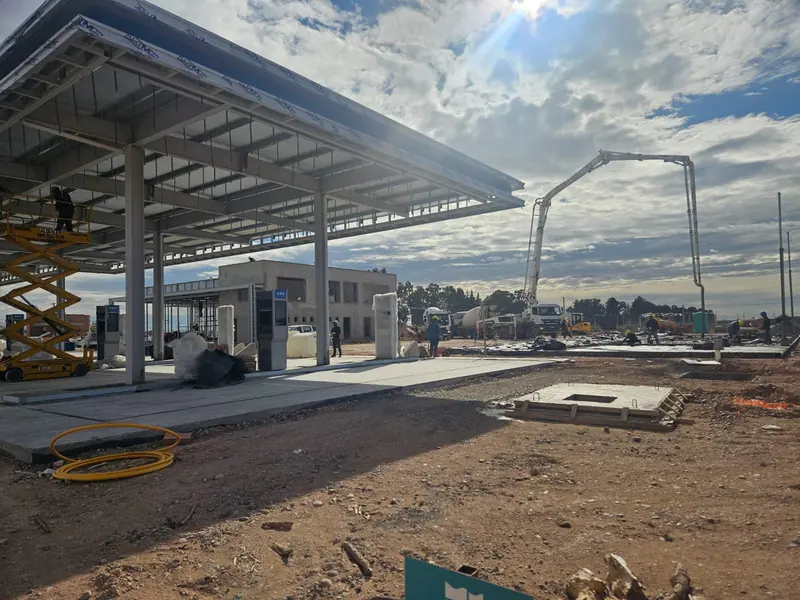 Concrete pump working on the forecourt next to the completed canopy